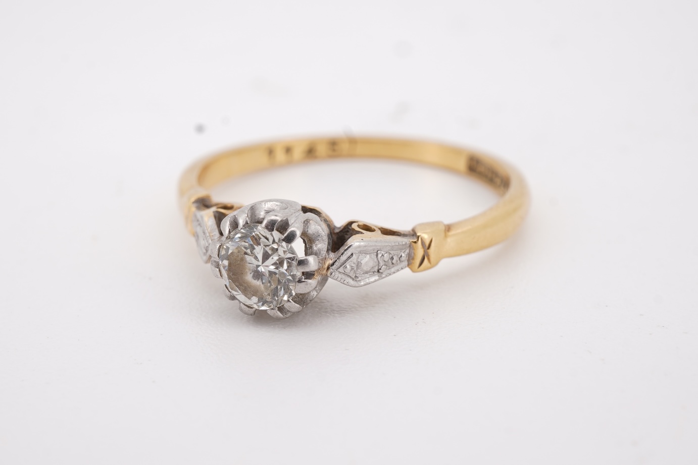 A diamond ring, set with a brilliant-cut diamond weighing approximately 0.20 carats, mounted in gold and platinum, size O1/2, stamped 18CT PLAT, gross weight approximately 2 grams, Condition: good, minor wear, diamond es
